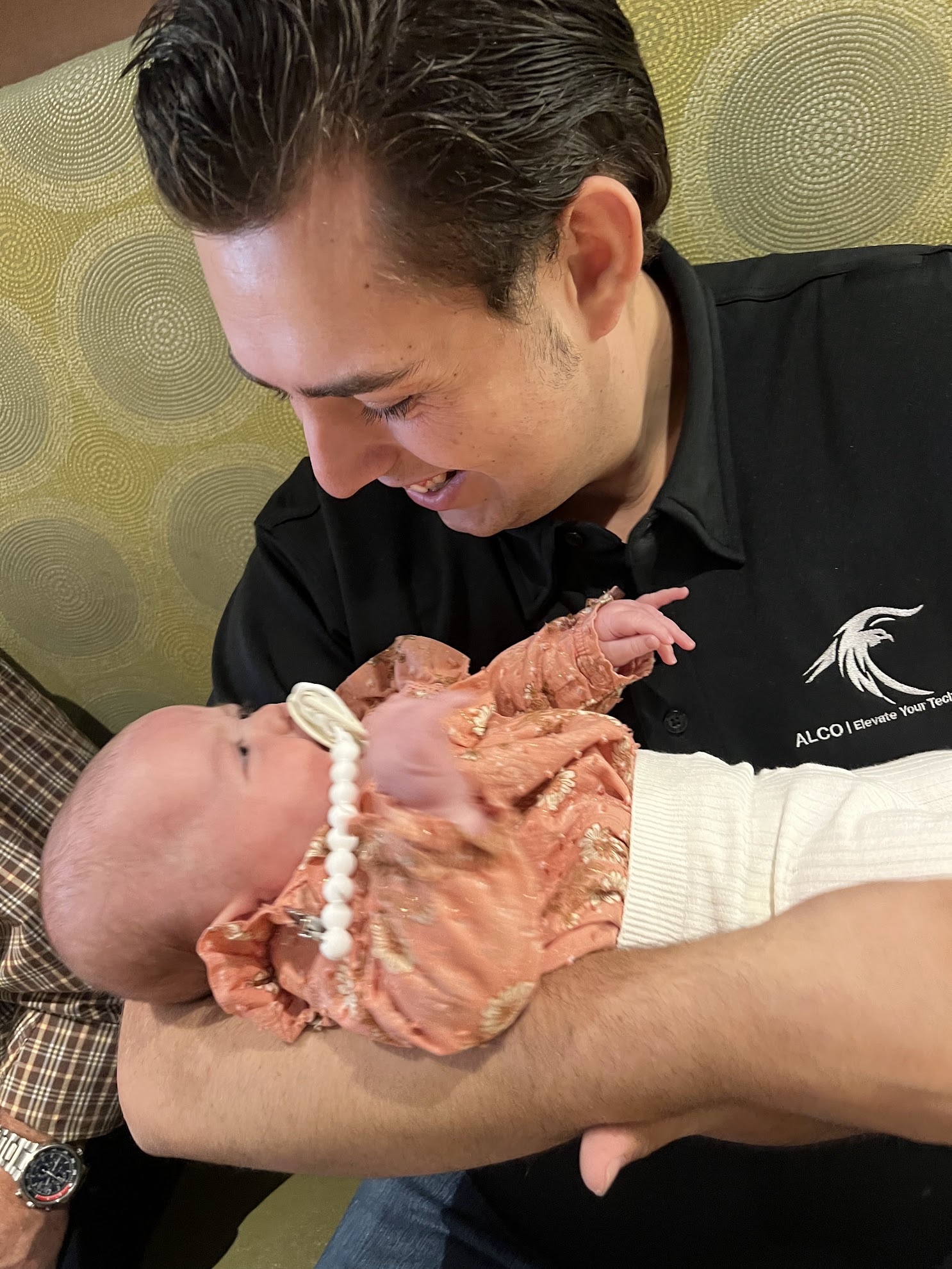 Adam Leveille meeting his newborn niece during a 2025 client trip.
