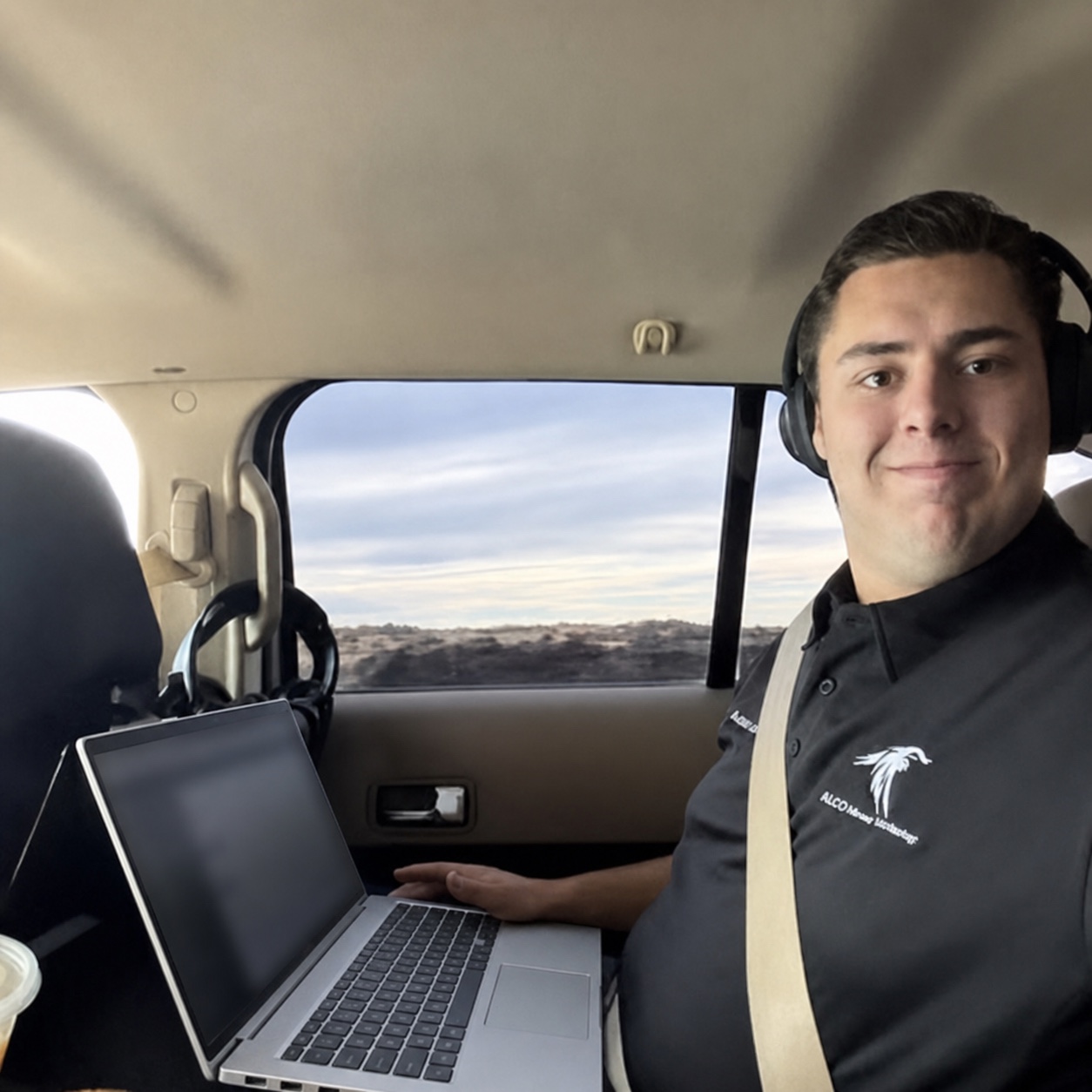 Adam Leveille working securely from a laptop during a travel day.