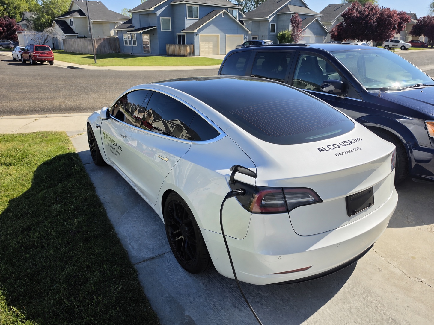 A former ALCO Tesla field-service vehicle charging between trips.