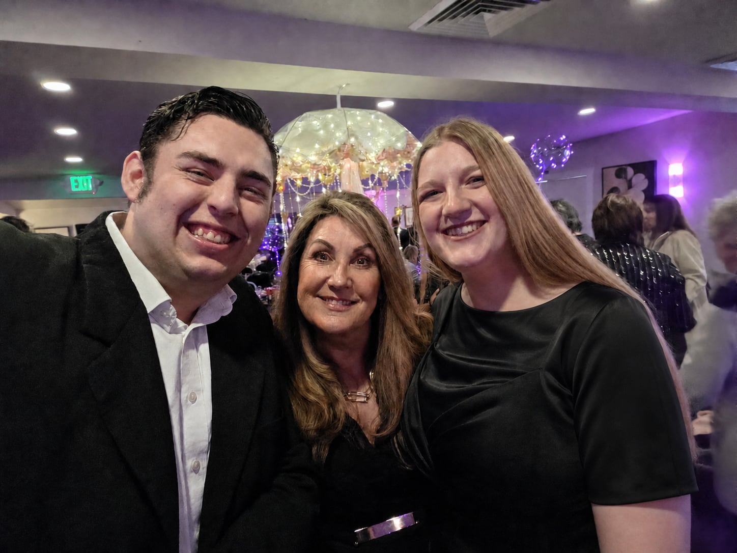 Adam and Carly Leveille with another attendee at a nonprofit fundraising gala.