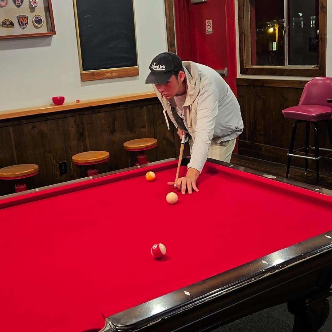 Adam Leveille playing pool during an ALCO company outing.