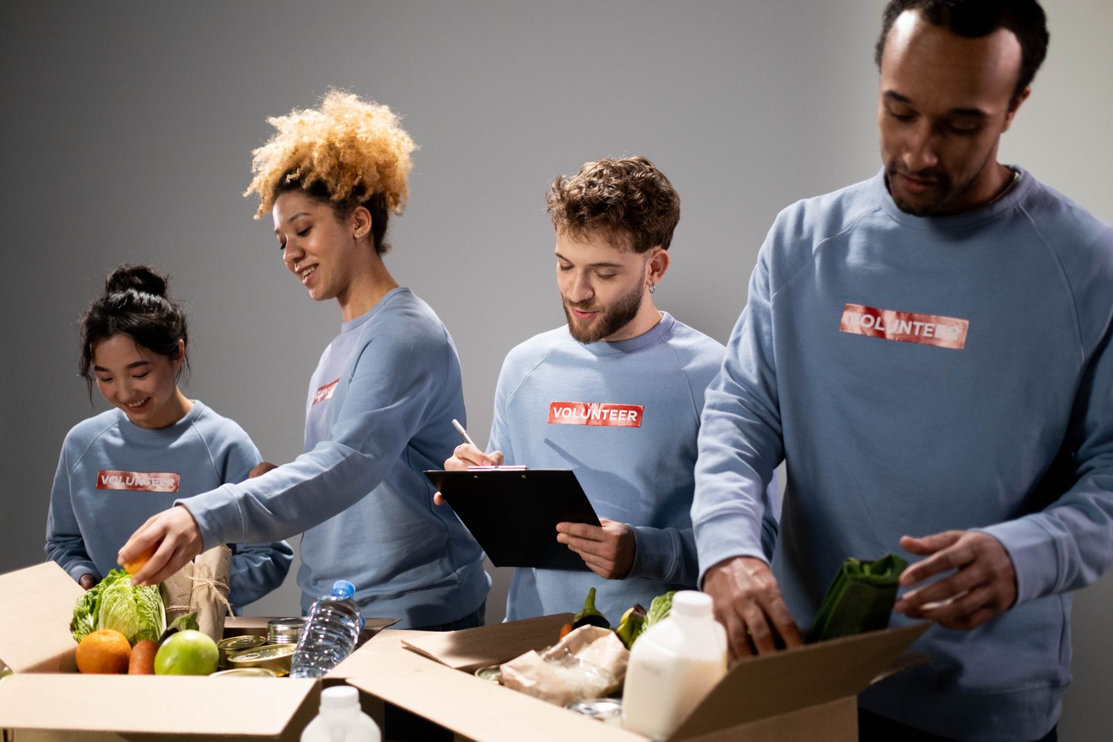 Volunteers packing fresh food and supplies for community donations.