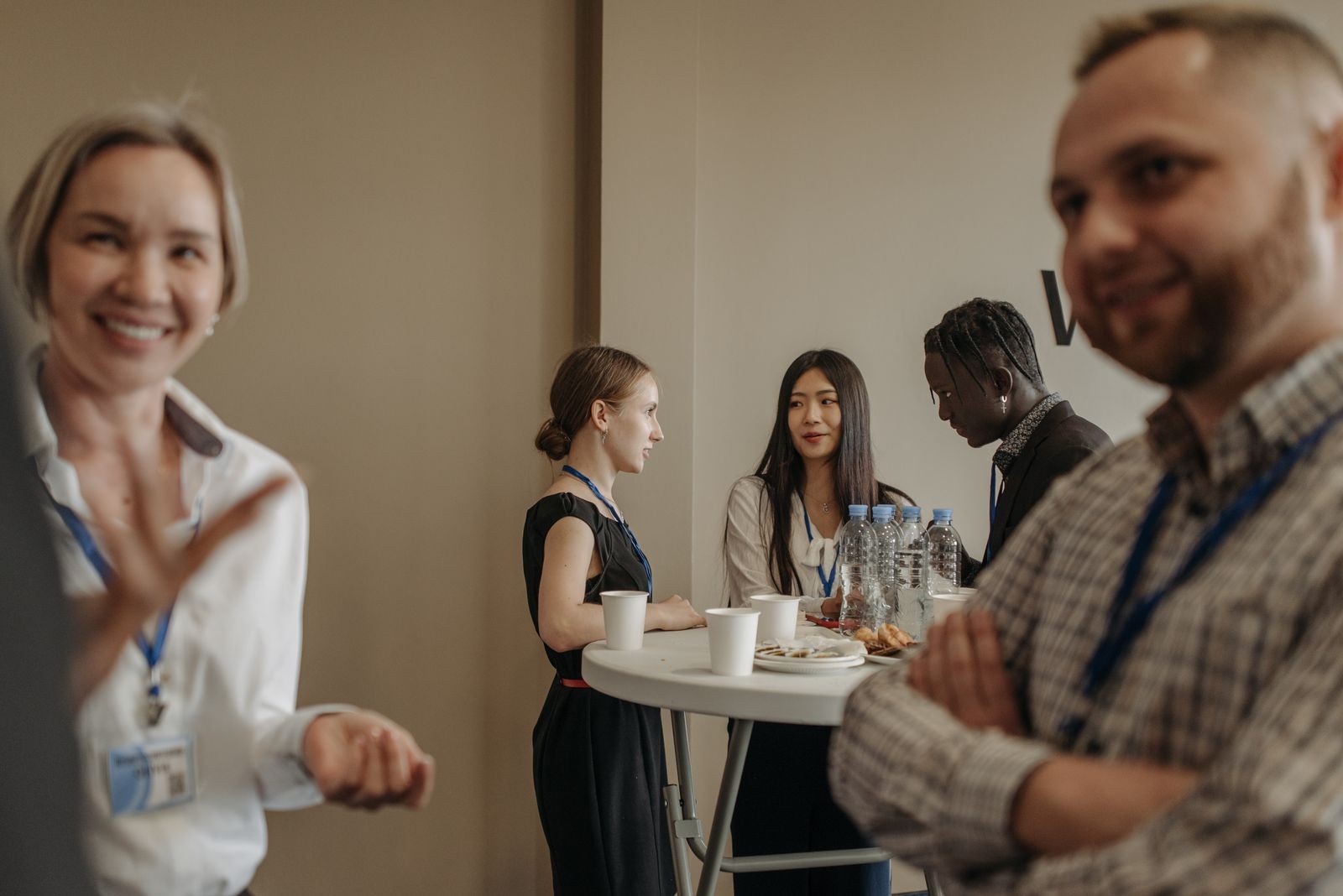 Professionals networking around a conference table.