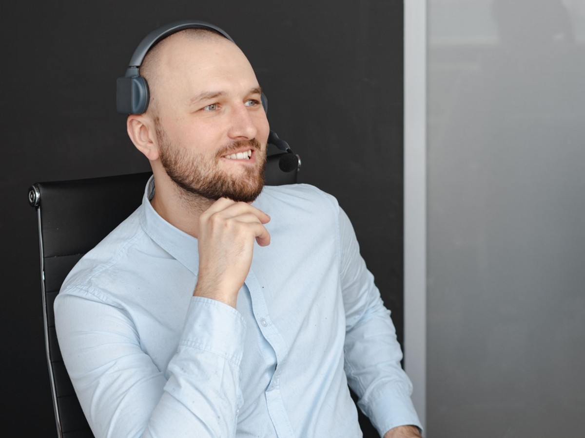 Customer support professional wearing a headset.